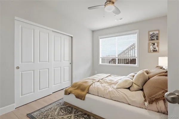 a bedroom with a bed and wooden floor