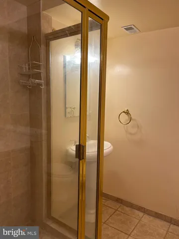 a bathroom with a glass shower door