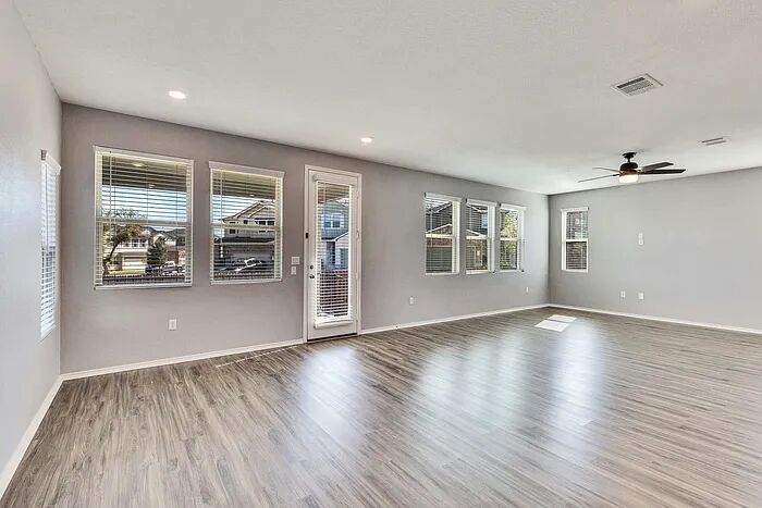 10403 Bramble Berry Drive Austin, TX 78748 - Photo 6 of 21 a view of an empty room with wooden floor and a window