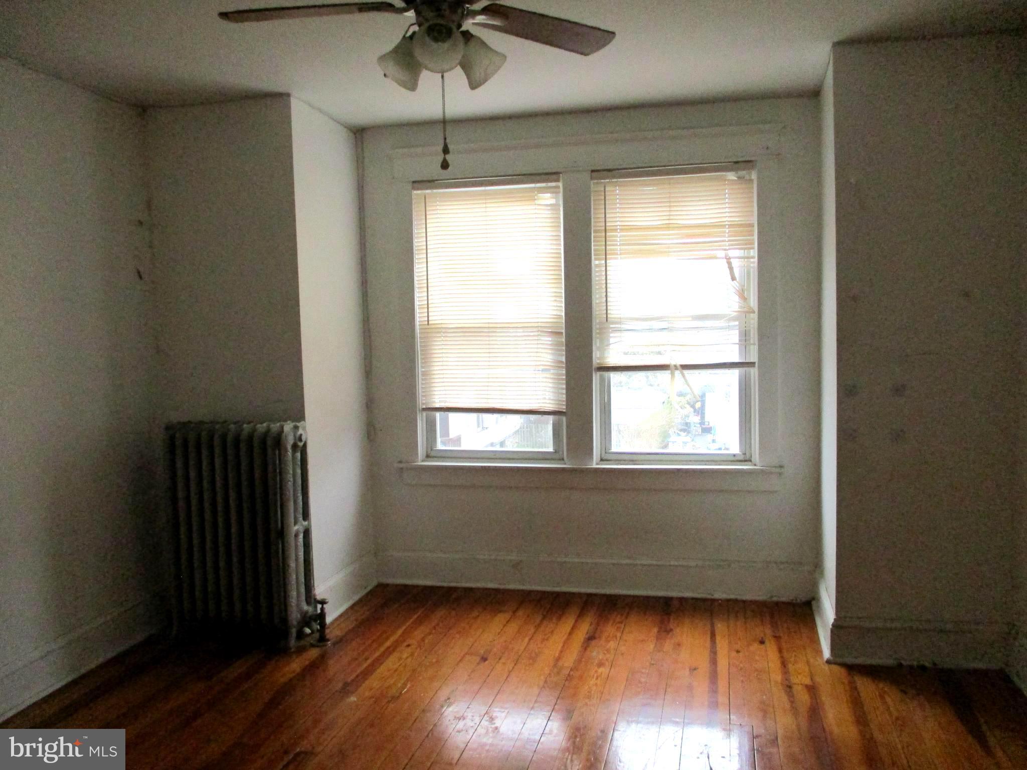 30 North Ridgeway Avenue Glenolden, PA 19036 - Photo 11 of 20 an empty room with wooden floor and windows
