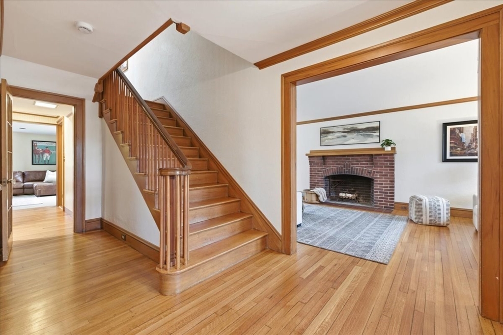 238 Harris Avenue Needham, MA 02492 - Photo 8 of 35 a view of a livingroom with wooden floor and a fireplace