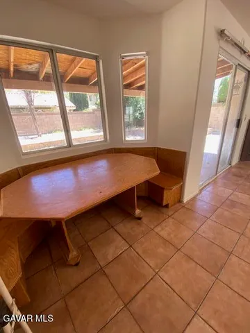 a room with pool table and windows