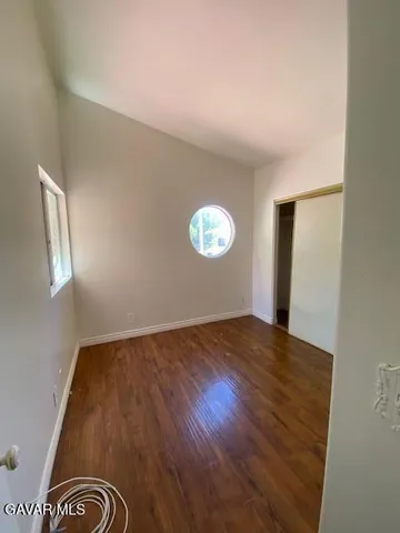 a view of an empty room and wooden floor