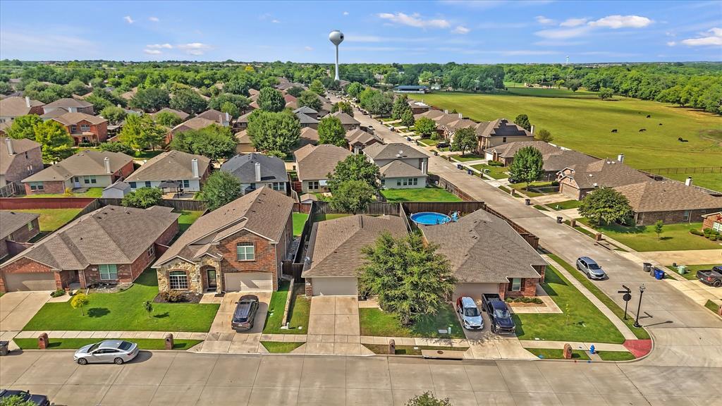 409 Harding Lane Lavon, TX 75166 - Photo 30 of 34 Aerial perspective of a residential neighborhood featuring established homes with brick and stone exteriors, asphalt shingle roofs, and attached two-car garages