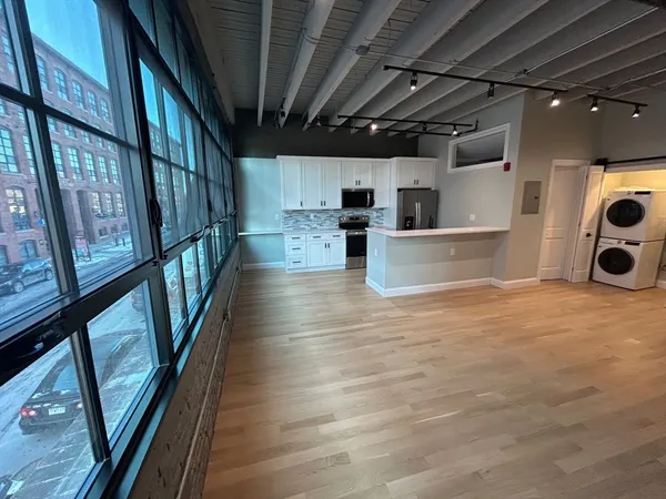 a view of living room with furniture and wooden floor