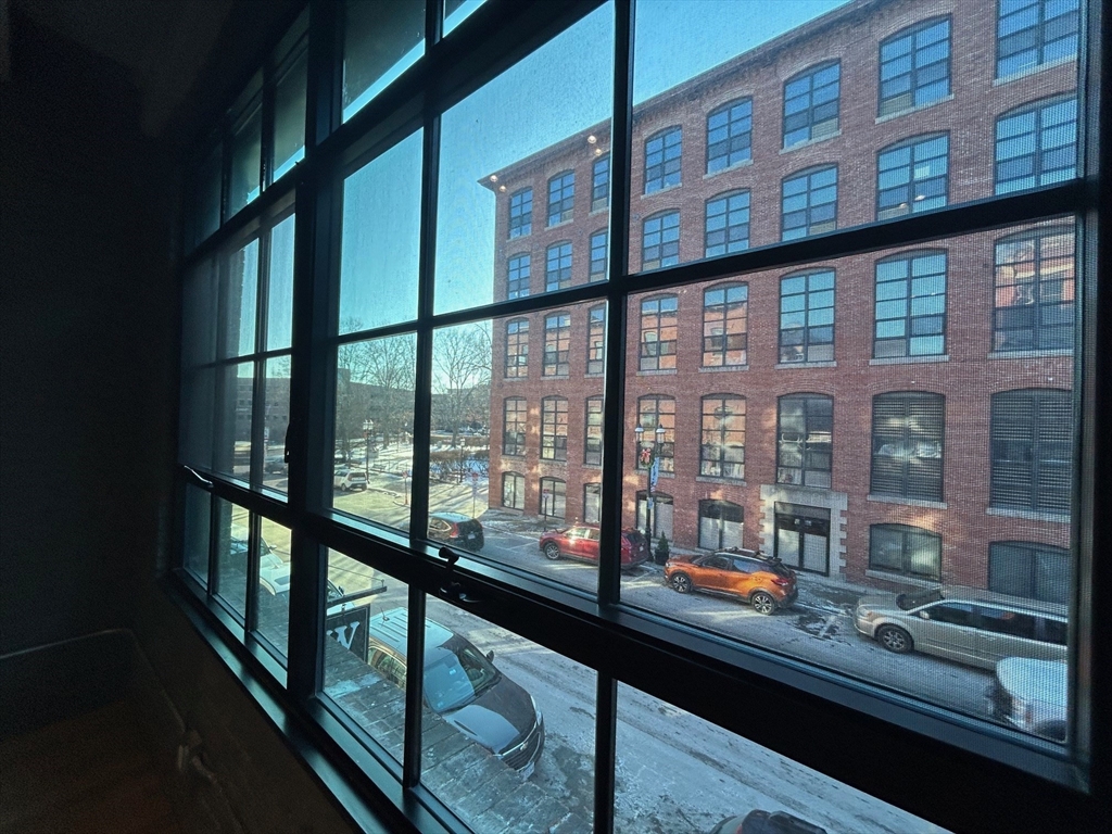 199 Market Street, Unit 1 Lowell, MA 01852 - Photo 3 of 8 a view of a building from a balcony