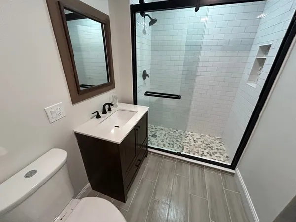 a bathroom with a sink toilet and shower