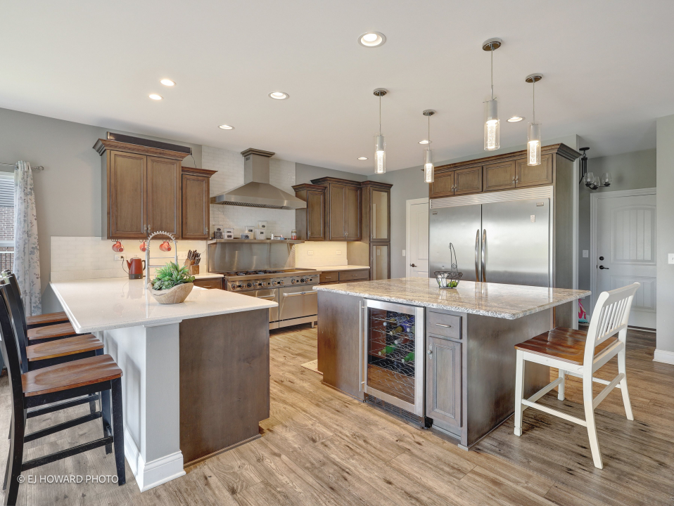 16308 Palomino Path Manhattan, IL 60442 - Photo 19 of 39 a kitchen with kitchen island granite countertop a sink and a refrigerator