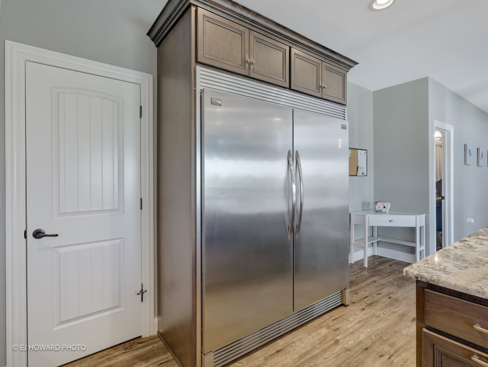 16308 Palomino Path Manhattan, IL 60442 - Photo 21 of 39 a kitchen with a refrigerator and wooden cabinets