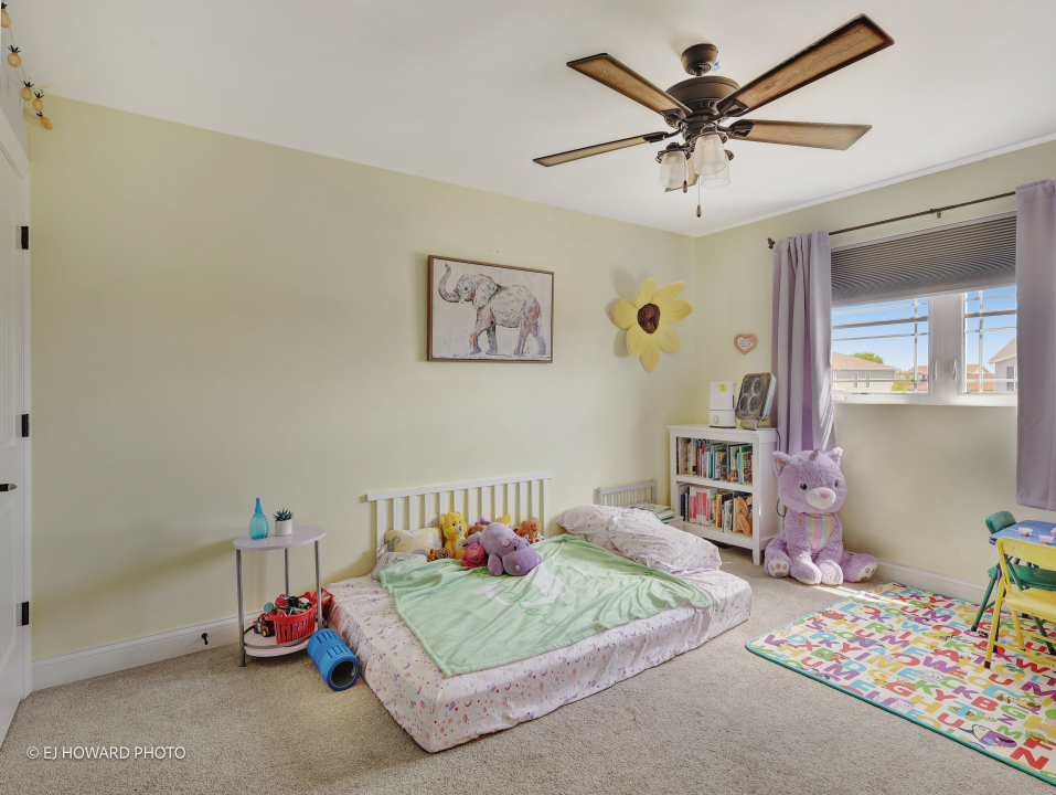 16308 Palomino Path Manhattan, IL 60442 - Photo 28 of 39 a bedroom with a bed and a chandelier