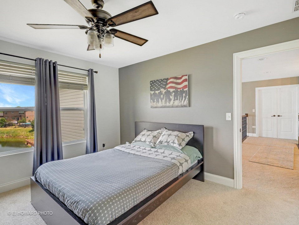 16308 Palomino Path Manhattan, IL 60442 - Photo 29 of 39 a bedroom with a bed and a chandelier