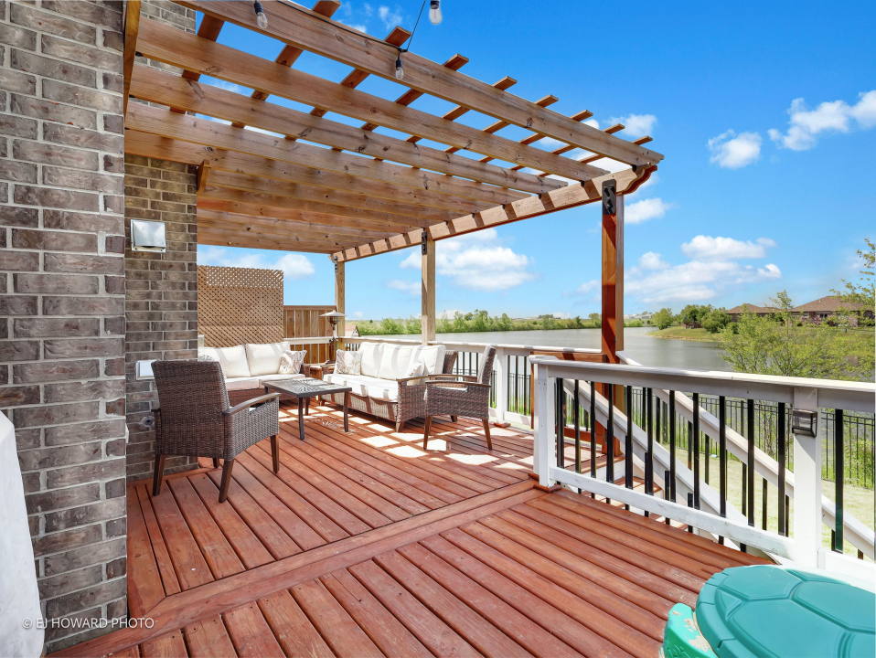 16308 Palomino Path Manhattan, IL 60442 - Photo 8 of 39 a view of a roof deck with table and chairs under an umbrella with wooden floor