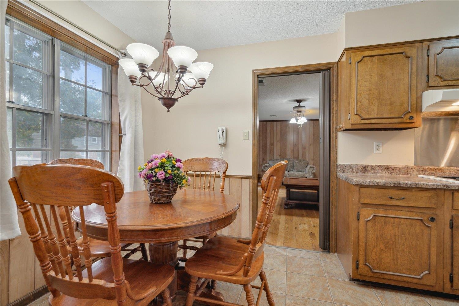 4839 Yale Road Memphis, TN 38128 - Photo 14 of 27 Dining room with a textured ceiling, light hardwood / wood-style floors, and ceiling fan with notable chandelier