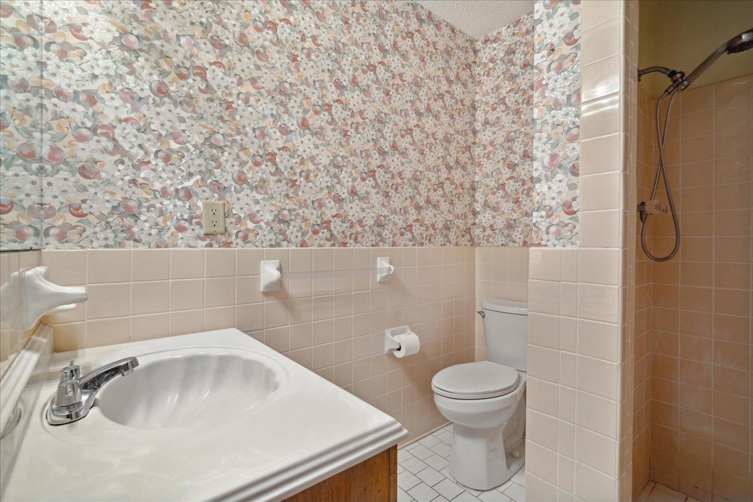 4839 Yale Road Memphis, TN 38128 - Photo 19 of 27 Bathroom with toilet, tile patterned floors, tile walls, vanity, and a shower