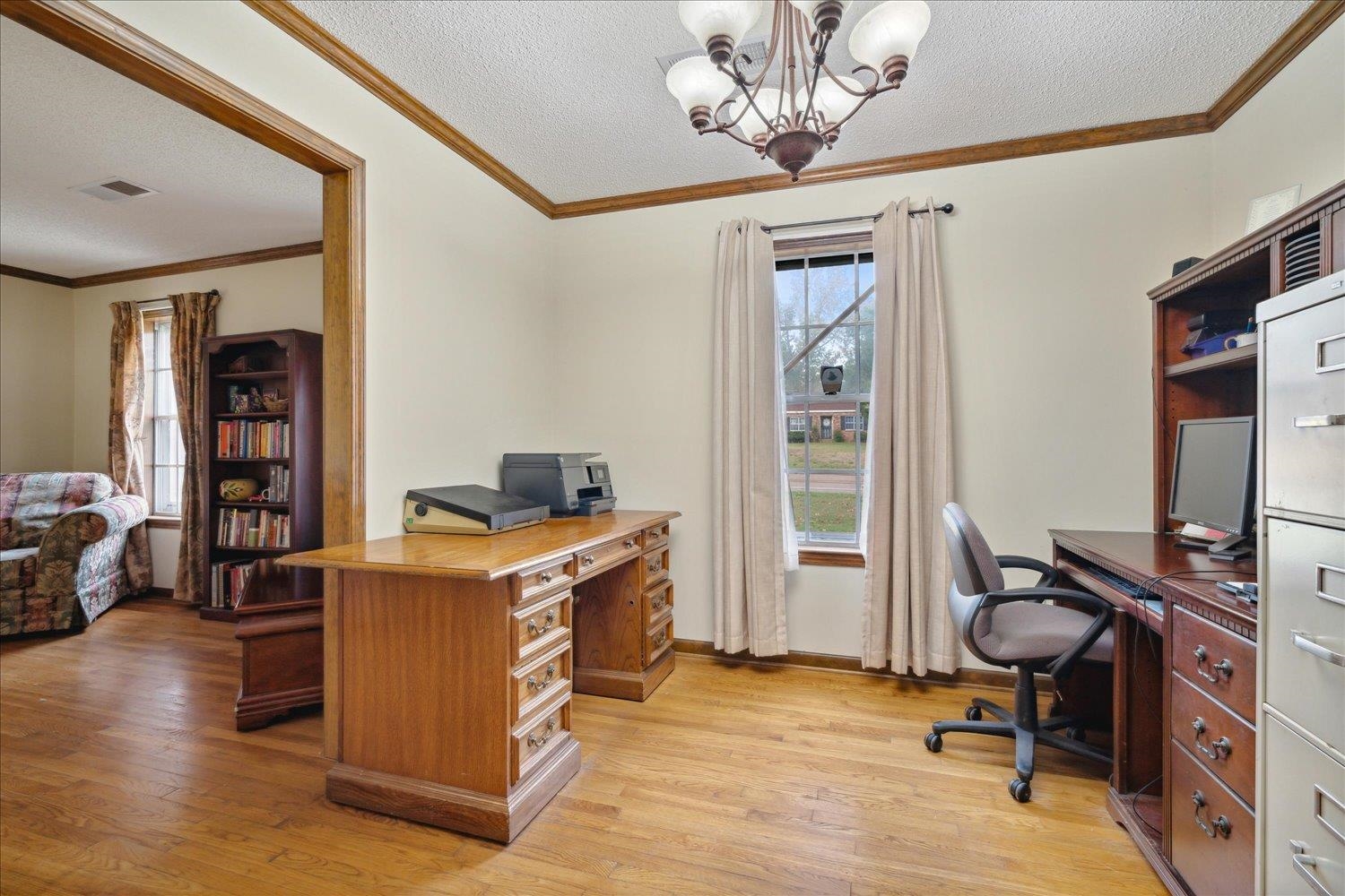 4839 Yale Road Memphis, TN 38128 - Photo 8 of 27 Office space featuring light hardwood / wood-style floors, a textured ceiling, crown molding, and a notable chandelier