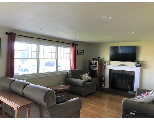 219 Marion Road Rochester, MA 02770 - Photo 2 of 20 a living room with furniture a flat screen tv and a fireplace