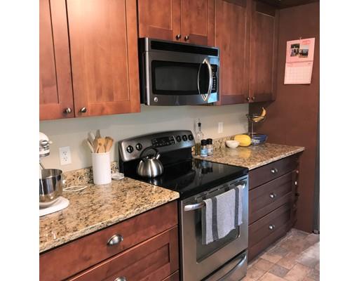 219 Marion Road Rochester, MA 02770 - Photo 5 of 20 a kitchen with a sink stove and microwave