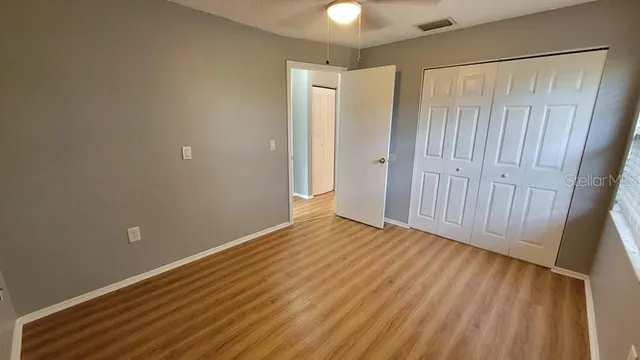 a view of an empty room with wooden floor