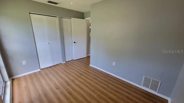 a view of a room with wooden floor and staircase