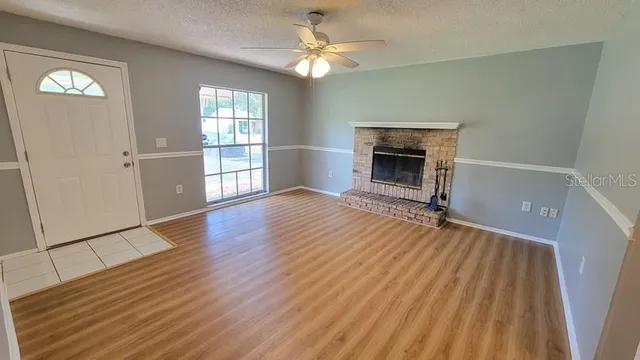 wooden floor fireplace and natural light in room