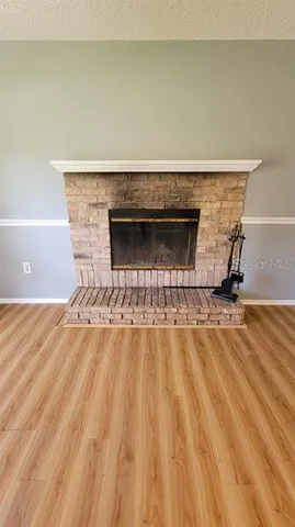 a view of a livingroom with wooden floor and staircase