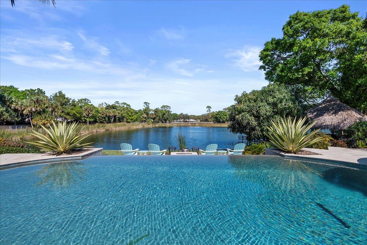 10975 Randolph Siding Road Jupiter, FL 33478 - Photo 54 of 97 a view of a lake with houses in the back