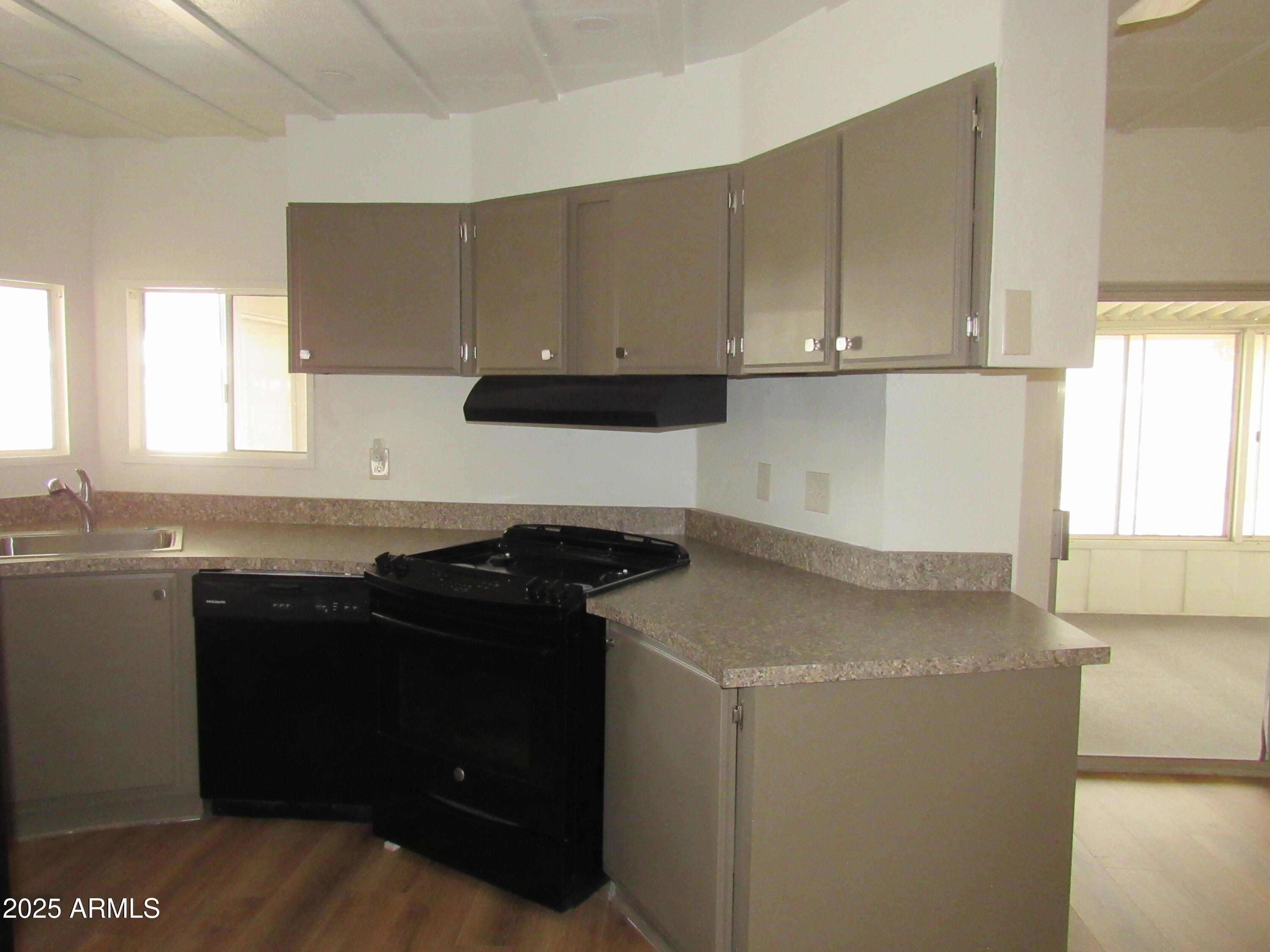 3411 South Camino Seco, Unit 70 Tucson, AZ 85730 - Photo 11 of 22 a kitchen with a sink and cabinets