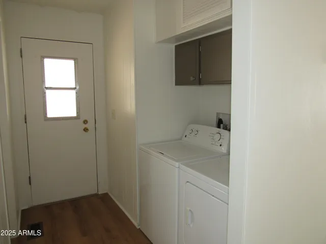 a utility room with a sink dryer and washer