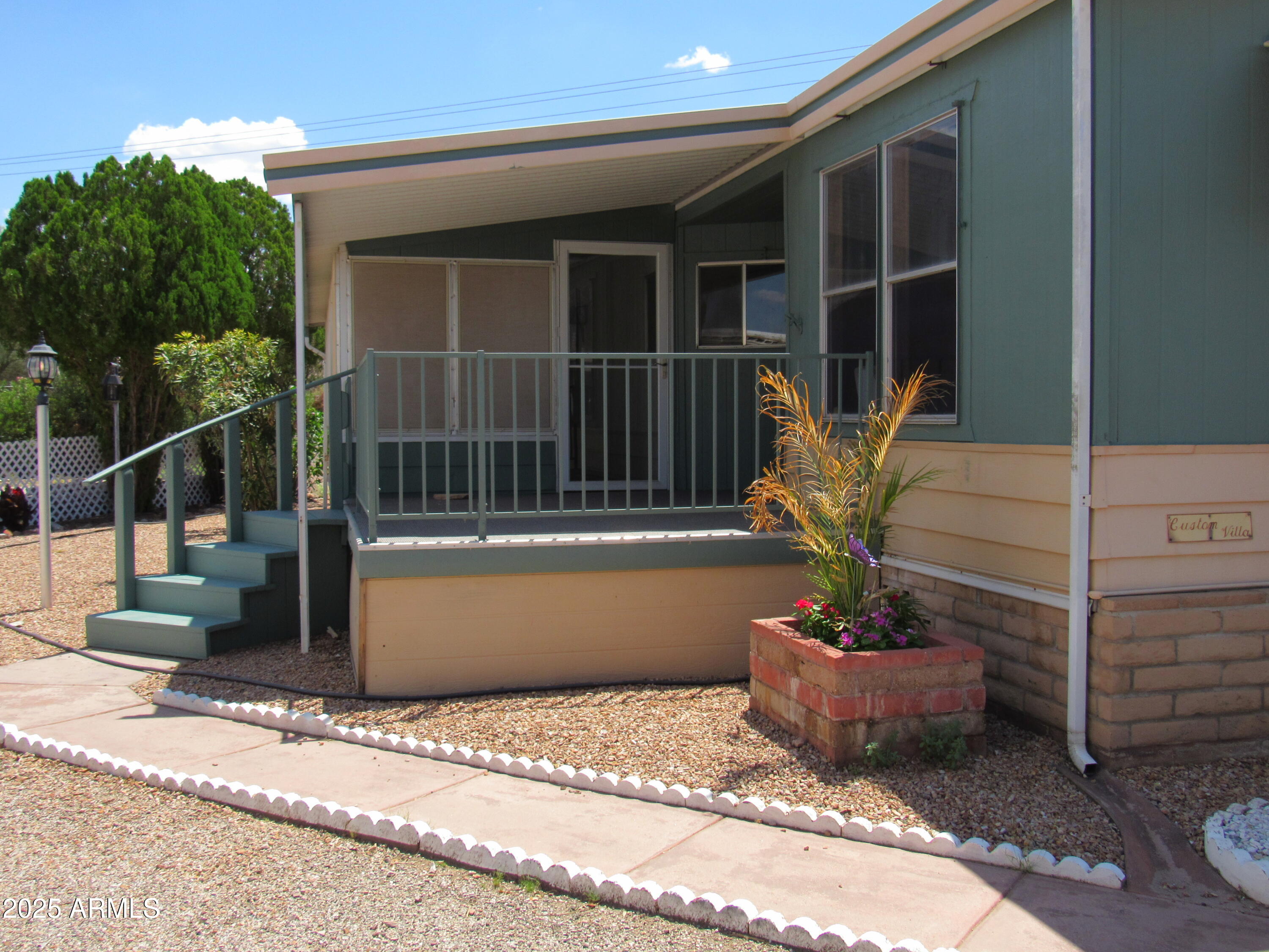 3411 South Camino Seco, Unit 70 Tucson, AZ 85730 - Photo 3 of 22 a view of a house with a potted plant and a sink