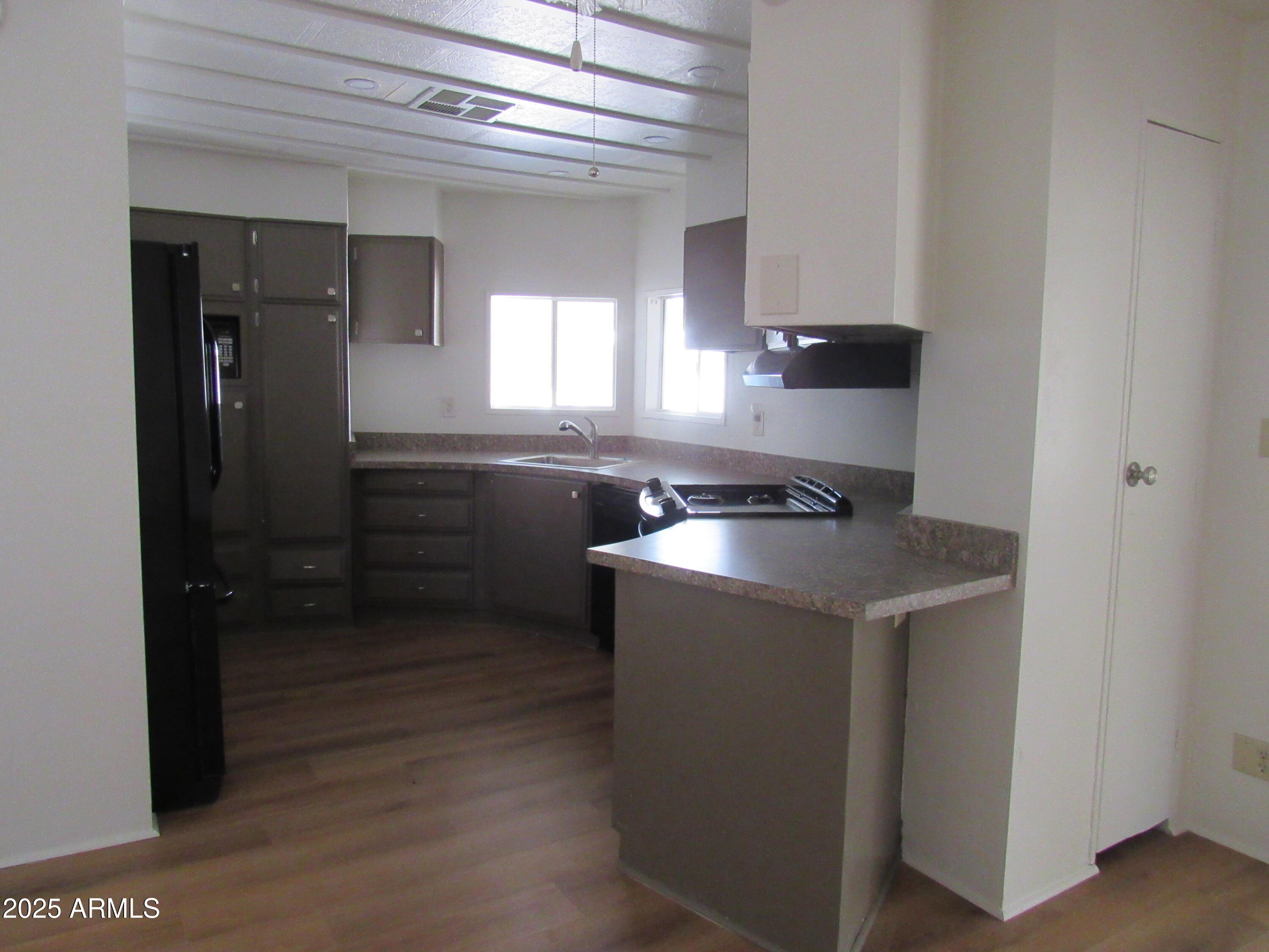 3411 South Camino Seco, Unit 70 Tucson, AZ 85730 - Photo 9 of 22 a kitchen with a sink and cabinets