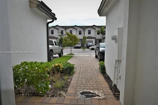 a view of a pathway of a house with backyard