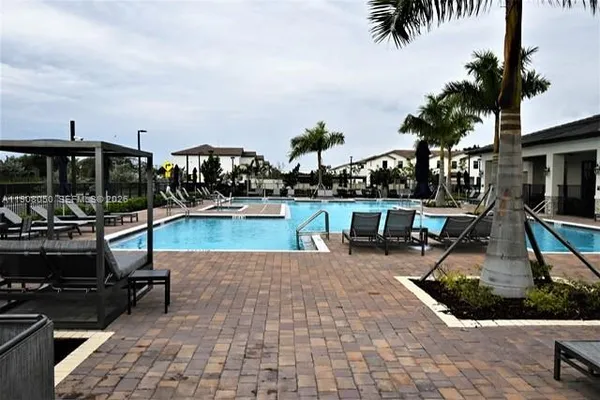 a view of a swimming pool with chairs