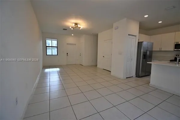 a view of a kitchen with a refrigerator and a window