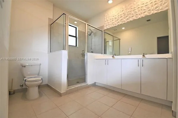a bathroom with a toilet sink and shower