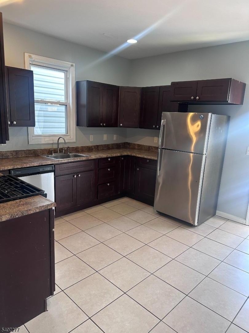 527 South 16th Street Newark, NJ 07103 - Photo 3 of 10 a kitchen with stainless steel appliances granite countertop a refrigerator and a stove