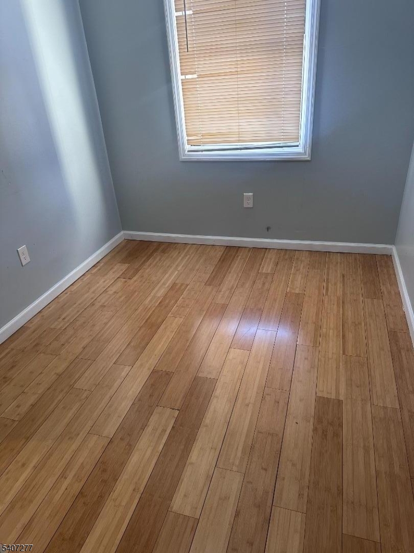 527 South 16th Street Newark, NJ 07103 - Photo 6 of 10 an empty room with wooden floor and windows