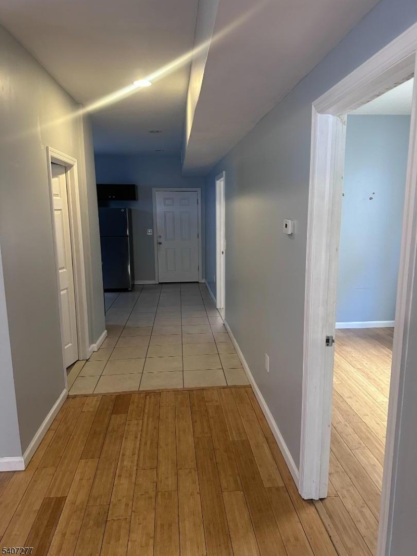527 South 16th Street Newark, NJ 07103 - Photo 10 of 10 a view of a hallway with wooden floor and a bathroom