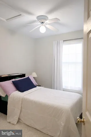 a view of a bedroom with wooden floor and a bathroom