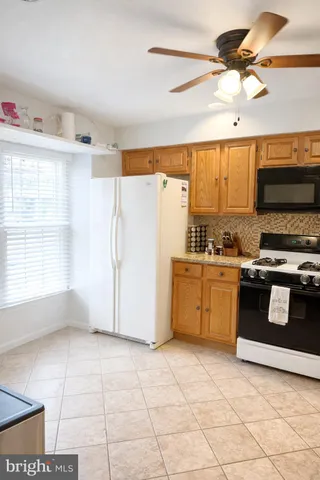 a kitchen with stainless steel appliances a stove a sink and a microwave