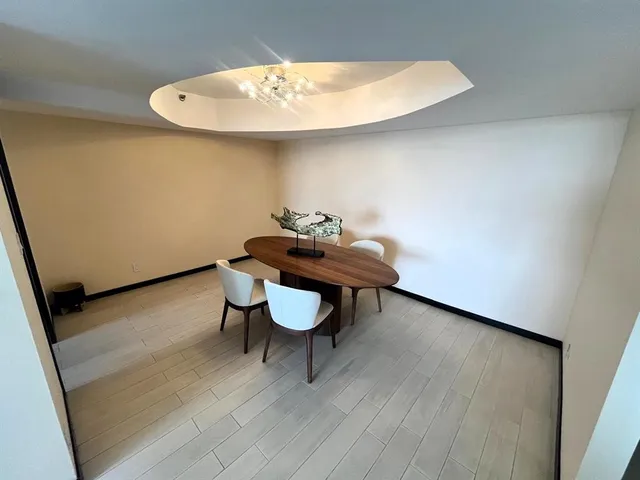 a view of a room with furniture and wooden floor