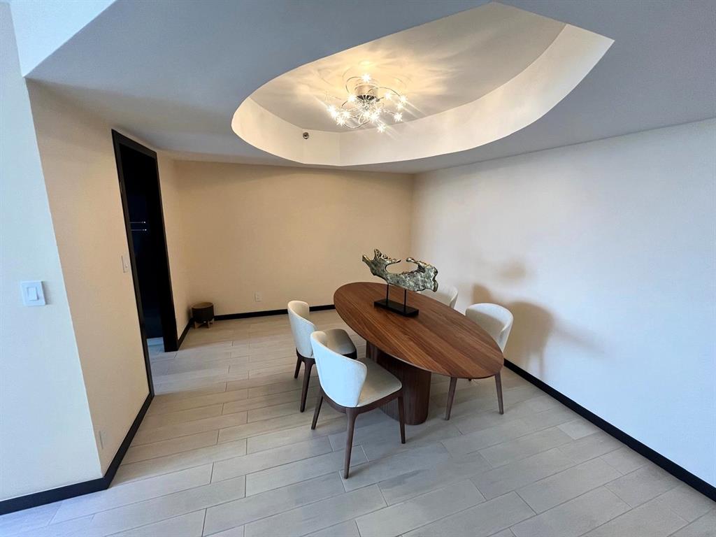 19707 Turnberry Way, Unit 8L Miami, FL 33180 - Photo 12 of 39 a room with furniture and a potted plant