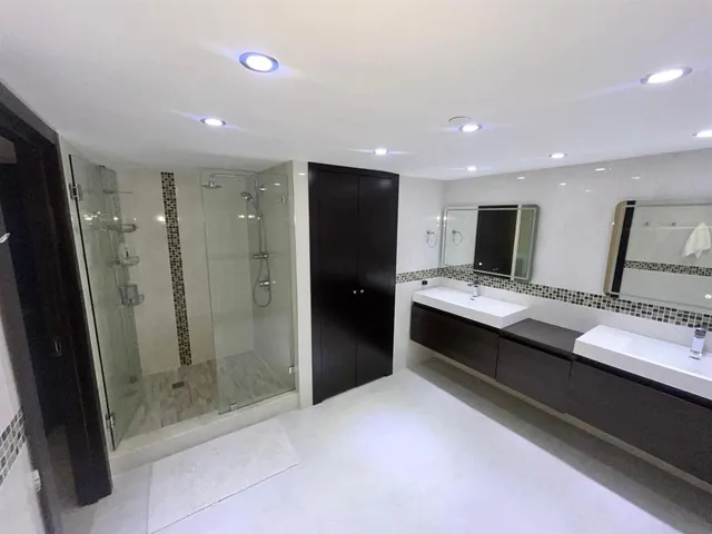 a bathroom with a double vanity sink and mirror