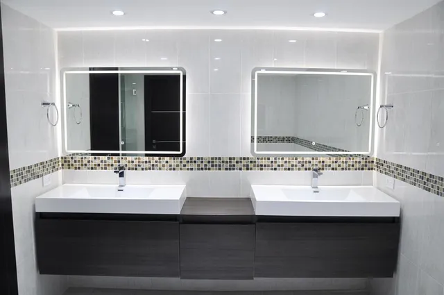 a bathroom with a double vanity sink mirror and double