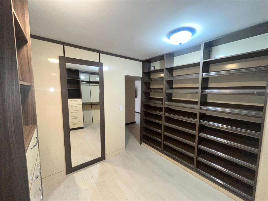 19707 Turnberry Way, Unit 8L Miami, FL 33180 - Photo 24 of 39 a view of closet area with empty racks