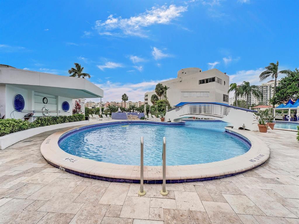 19707 Turnberry Way, Unit 8L Miami, FL 33180 - Photo 35 of 39 a view of a swimming pool with a yard