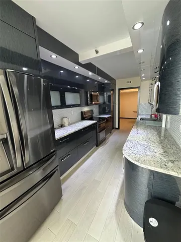 a kitchen with kitchen island a counter top