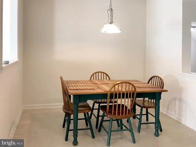 a view of a dining room with furniture and chandelier