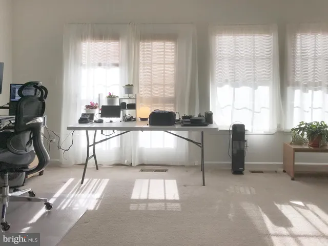 a kitchen with a sink a counter top space and living room area