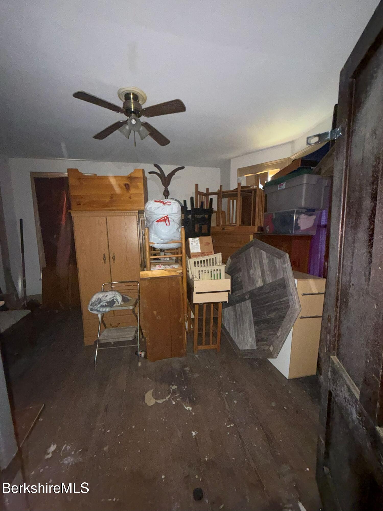 32-38 Spring Street North Adams, MA 01247 - Photo 16 of 32 a room with water heater and wooden cabinets
