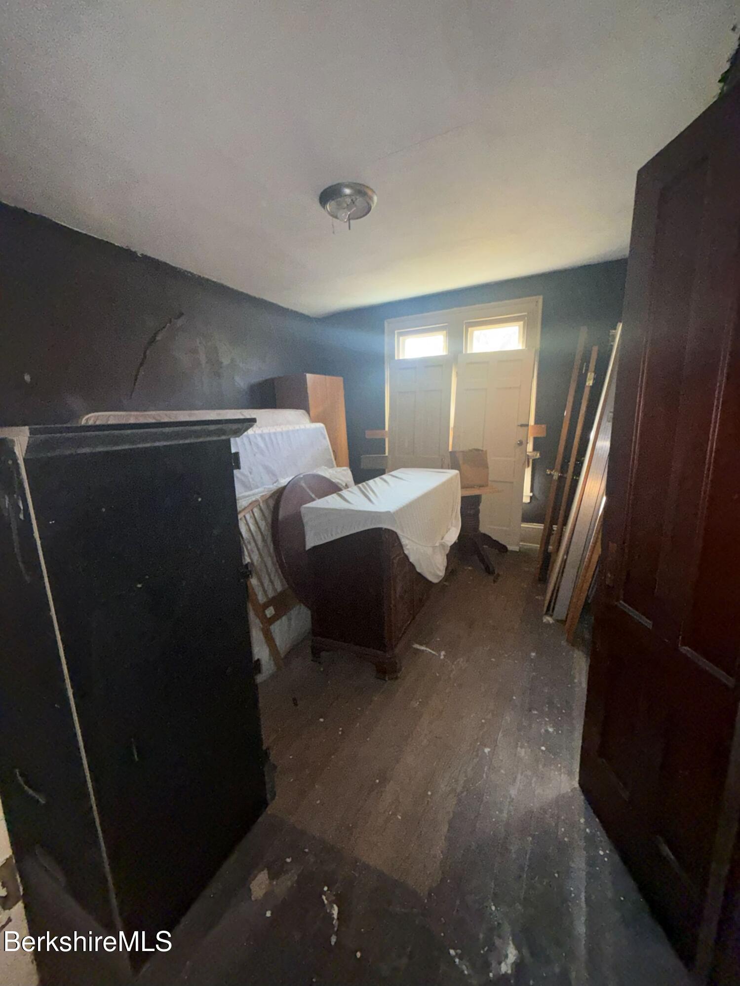 32-38 Spring Street North Adams, MA 01247 - Photo 29 of 32 a bedroom with a bed and a large mirror